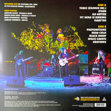 Cargar imagen en el visor de la galería, Album cover with band performing on stage and colorful abstract design