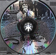 Cargar imagen en el visor de la galería, Disc with a stylized image of a person and abstract design on a textured background