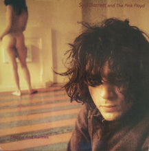 Cargar imagen en el visor de la galería, Album cover with a person in a brown jacket and another figure in the background, featuring text about Syd Barrett and Pink Floyd.
