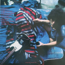 Cargar imagen en el visor de la galería, Person holding a guitar and striped blanket with album tracklist on a blue couch
