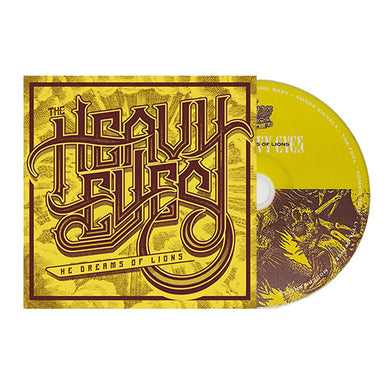 The Heavy Eyes - He Dreams Of Lions compact disc and album cover with yellow and brown design featuring text and a logo.
