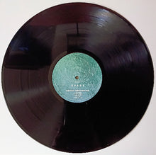 Charger l'image dans la galerie, Vinyl record with a green label on a white background