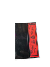 Cargar imagen en el visor de la galería, Black cassette tape with a red label on a white background