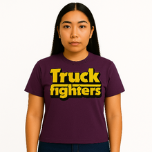 Cargar imagen en el visor de la galería, Person wearing a purple t-shirt with &#39;Truck fighters&#39; text in yellow and black.