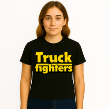 Cargar imagen en el visor de la galería, Person wearing a black t-shirt with &#39;Truck fighters&#39; in yellow text on a white background