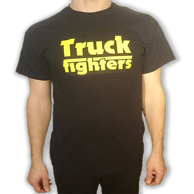 Person wearing a black t-shirt with 'Truck fighters' in yellow text on a white background