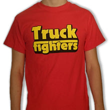 Cargar imagen en el visor de la galería, A person wearing a red t-shirt with the text &#39;TRUCK FIGHTERS&#39; printed in yellow.