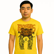 Load image into Gallery viewer, Man wearing a yellow t-shirt with a graphic design and text
