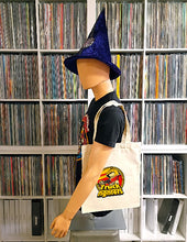 Cargar imagen en el visor de la galería, Mannequin wearing a blue witch hat and carrying a tote bag with a logo in front of a shelf of vinyl records.