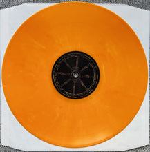 Cargar imagen en el visor de la galería, Orange vinyl record with a white border on a textured surface