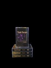 Cargar imagen en el visor de la galería, Stack of 'Vault Keeper' cassette tapes with a clear acrylic stand on a black background.