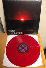 Charger l'image dans la galerie, Red vinyl record with a black cover displaying 'Void Cruiser' on a wooden surface.