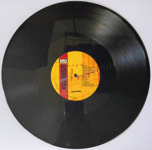 Cargar imagen en el visor de la galería, Vinyl record with a yellow label on a white background
