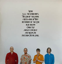 Cargar imagen en el visor de la galería, Four people standing in front of a white background with black text