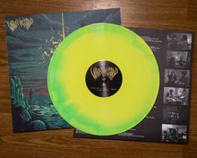 Charger l'image dans la galerie, Vinyl record with a green and yellow disc and cover on a wooden surface