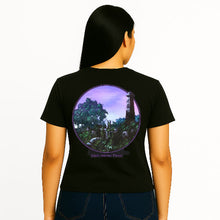 Load image into Gallery viewer, Person wearing a black t-shirt with a circular design on the back, featuring a scenic landscape.