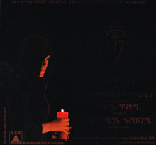 Cargar imagen en el visor de la galería, Person holding a candle in the dark with text and logos on the black background