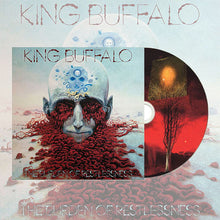 Load image into Gallery viewer, Album artwork and CD for “King Buffalo – The Burden of Restlessness,” featuring a surreal illustration of a pale, bald head with closed eyes and blue circular markings on the scalp, while red, brain-like tendrils flow outward across a barren landscape; the CD beside it shows a red-toned scene with a lone tree and glowing light.