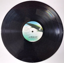 Cargar imagen en el visor de la galería, Vinyl record with a label on a white background
