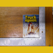 Load image into Gallery viewer, Card game box titled 'Truckfighters' on a wooden surface with a ruler for scale.